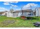 The backyard features green grass, a white lattice deck, and a trampoline, perfect for outdoor fun and relaxation at 3110 S Temple Ave, Indianapolis, IN 46237