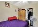 Bedroom features comfortable purple bed, wardrobe, closet and fan, creating a relaxing and functional space at 3110 S Temple Ave, Indianapolis, IN 46237