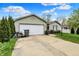 Cozy one-story home with an attached garage, a well-kept lawn, and tasteful landscaping at 3110 S Temple Ave, Indianapolis, IN 46237
