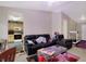 Living room view with black leather sofas and a view to the bright kitchen at 3110 S Temple Ave, Indianapolis, IN 46237