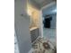 Bathroom featuring a sink, mirror, cabinet, and tiled flooring at 3302 S Rybolt Ave, Indianapolis, IN 46221