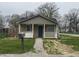Charming bungalow featuring a stone facade, covered porch, and well-maintained front yard at 3302 S Rybolt Ave, Indianapolis, IN 46221