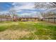 Spacious backyard with a large brick house, patio, trees, and lawn at 3502 River Park Dr, Anderson, IN 46012