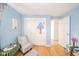 Bedroom featuring wood floors, blue walls, closet with playful design, and natural light at 3502 River Park Dr, Anderson, IN 46012