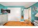 Bedroom with hardwood floors, blue walls, closet, bed, and natural light at 3502 River Park Dr, Anderson, IN 46012