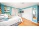 Bright bedroom with hardwood floors, blue walls, a bed, and natural light at 3502 River Park Dr, Anderson, IN 46012