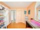 Bedroom featuring hardwood floors, peach walls, vanity, bright window, and closet at 3502 River Park Dr, Anderson, IN 46012