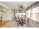 Bright dining area with a round wooden table, decorative ceiling fan, and sunlit windows at 3502 River Park Dr, Anderson, IN 46012