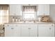 Functional kitchen with white cabinets, neutral countertops, and modern appliances for everyday convenience at 3502 River Park Dr, Anderson, IN 46012