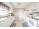 Bright kitchen featuring white cabinets, tile flooring, and essential appliances for convenient cooking at 3502 River Park Dr, Anderson, IN 46012