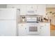 Efficient kitchen layout with white appliances, ample counter space, and modern cabinetry for storage at 3502 River Park Dr, Anderson, IN 46012