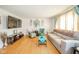 Bright living room featuring hardwood floors, comfortable seating, and a large mounted television at 3502 River Park Dr, Anderson, IN 46012