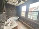 This rundown bathroom has a floral wall pattern, tub and vanity at 359 W 26Th St, Indianapolis, IN 46208