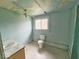 Dilapidated bathroom features a standard toilet, vanity and window at 359 W 26Th St, Indianapolis, IN 46208