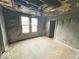 Damaged bedroom has hardwood floors, two windows, and a ceiling fan at 359 W 26Th St, Indianapolis, IN 46208