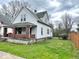 The side view of a traditional two-story home with an inviting brick porch and quaint windows at 359 W 26Th St, Indianapolis, IN 46208