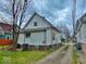A rear view of a two-story house with a backyard access road and green space at 359 W 26Th St, Indianapolis, IN 46208