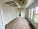 A bright room with hardwood floors, and large windows offering great potential for renovation at 359 W 26Th St, Indianapolis, IN 46208