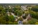 An aerial view showcasing a residential neighborhood with tree-lined streets and nearby amenities at 3738 Barrington Dr, Carmel, IN 46033