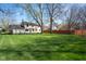 A large backyard with a green lawn and mature trees, offering privacy and space for outdoor activities at 3738 Barrington Dr, Carmel, IN 46033
