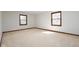 Bright bedroom with plush carpeting, natural light from two windows, and warm wood trim at 3738 Barrington Dr, Carmel, IN 46033