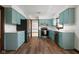 Well-lit kitchen featuring sleek appliances, quartz counters, and stylish blue cabinets at 3738 Barrington Dr, Carmel, IN 46033