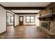 Inviting living room featuring a stone fireplace and wood beam accents, creating a cozy atmosphere at 3738 Barrington Dr, Carmel, IN 46033
