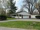 Ranch style home with attached garage, brick accents, white siding, and a quaint, covered porch at 4290 Manning Rd, Indianapolis, IN 46228