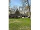 Lovely brick ranch-style home features green shutters, a white porch, and a well-kept lawn at 4290 Manning Rd, Indianapolis, IN 46228