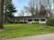 Charming ranch home features a brick exterior, white porch, green shutters, and a well-maintained lawn at 4290 Manning Rd, Indianapolis, IN 46228