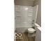 This bathroom has a tub-shower combo with built-in shelves and new flooring at 4311 Village Parkway W Cir # 6, Indianapolis, IN 46254