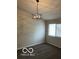 This bedroom has neutral walls, carpet, and a modern chandelier for comfortable living at 4311 Village Parkway W Cir # 6, Indianapolis, IN 46254