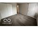 This empty bedroom has neutral walls, carpet, closet, and door at 4311 Village Parkway W Cir # 6, Indianapolis, IN 46254