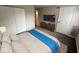 This staged bedroom offers a closet and media console beneath a modern TV at 4311 Village Parkway W Cir # 6, Indianapolis, IN 46254