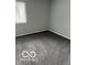 This bedroom has neutral walls, carpet, and a large window at 4311 Village Parkway W Cir # 6, Indianapolis, IN 46254