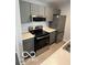 Modern kitchen with stainless steel appliances, gray cabinets, and bright countertops at 4311 Village Parkway W Cir # 6, Indianapolis, IN 46254