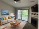 Bright living room with cozy fireplace and sliding doors to a private balcony at 4311 Village Parkway W Cir # 6, Indianapolis, IN 46254