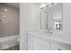 Beautiful bathroom with a white vanity, modern fixtures, and stylish gray tile shower at 456 E Arch St, Indianapolis, IN 46202