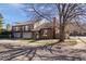 Charming brick home featuring balconies, a two-car garage, and mature trees in a residential neighborhood at 456 E Arch St, Indianapolis, IN 46202