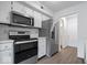 Well-equipped kitchen with stainless steel appliances and white cabinets at 456 E Arch St, Indianapolis, IN 46202