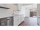 Bright kitchen featuring white cabinets, modern countertops, stainless steel appliances, and hardwood floors at 456 E Arch St, Indianapolis, IN 46202