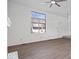 Bright living room with hardwood floors, a large window, and neutral-colored walls at 456 E Arch St, Indianapolis, IN 46202