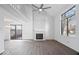 Open living area with hardwood floors, fireplace, ceiling fan and access to the backyard through sliding doors at 456 E Arch St, Indianapolis, IN 46202