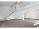 Open-concept living area with hardwood floors, staircase, dining area, and ample natural light at 456 E Arch St, Indianapolis, IN 46202