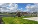 Large backyard featuring a wooden playset, swing set and trampoline overlooking a scenic pond at 530 Farnham Dr, Westfield, IN 46074