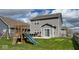 The backyard features a playset, dining table, and sliding glass door offering a great space to relax at 530 Farnham Dr, Westfield, IN 46074