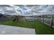Large backyard with a playset, swing set, and trampoline overlooking a scenic pond at 530 Farnham Dr, Westfield, IN 46074