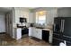 Modern kitchen featuring white cabinets, stainless steel appliances, and a black refrigerator at 530 Farnham Dr, Westfield, IN 46074