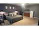 Spacious main bedroom featuring a king-sized bed, carpeted floors, and an exercise bike at 530 Farnham Dr, Westfield, IN 46074