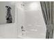 Clean white bathroom with a shower and tub combination, featuring a shower curtain and decorative wall art at 5311 Pelion Pl, McCordsville, IN 46055